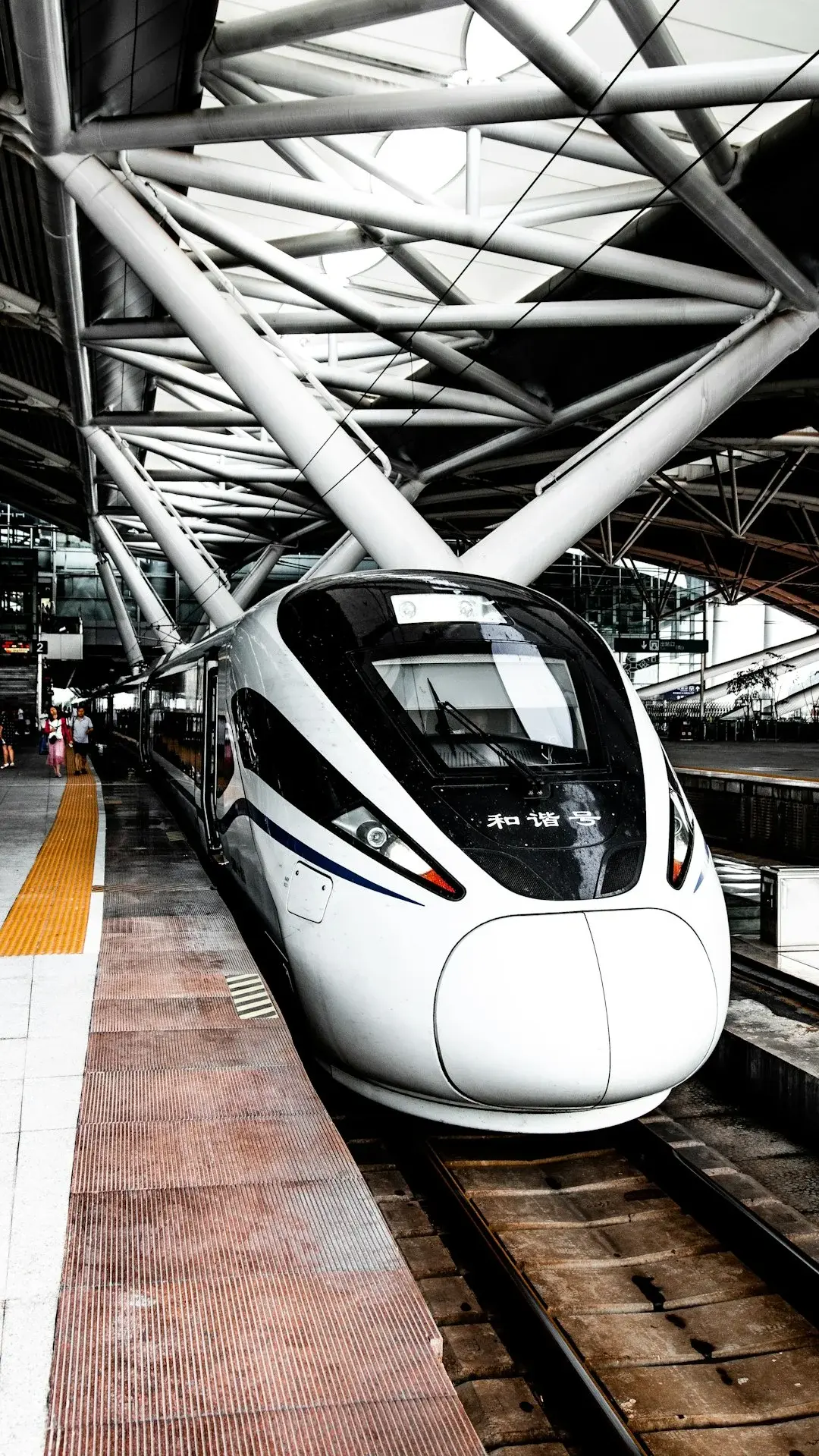 A family boarding a Chinese high-speed train on the platform